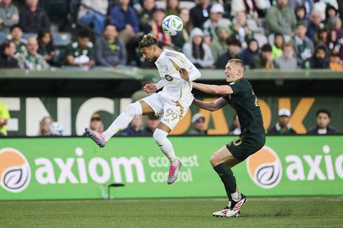 Apr 19, 2025; Portland, Oregon, USA; Los Angeles FC forward Denis Bouanga (99) heads the ball during the first half against Portland Timbers defender Finn Surman (20) at Providence Park. Mandatory Credit: Troy Wayrynen-Imagn Images