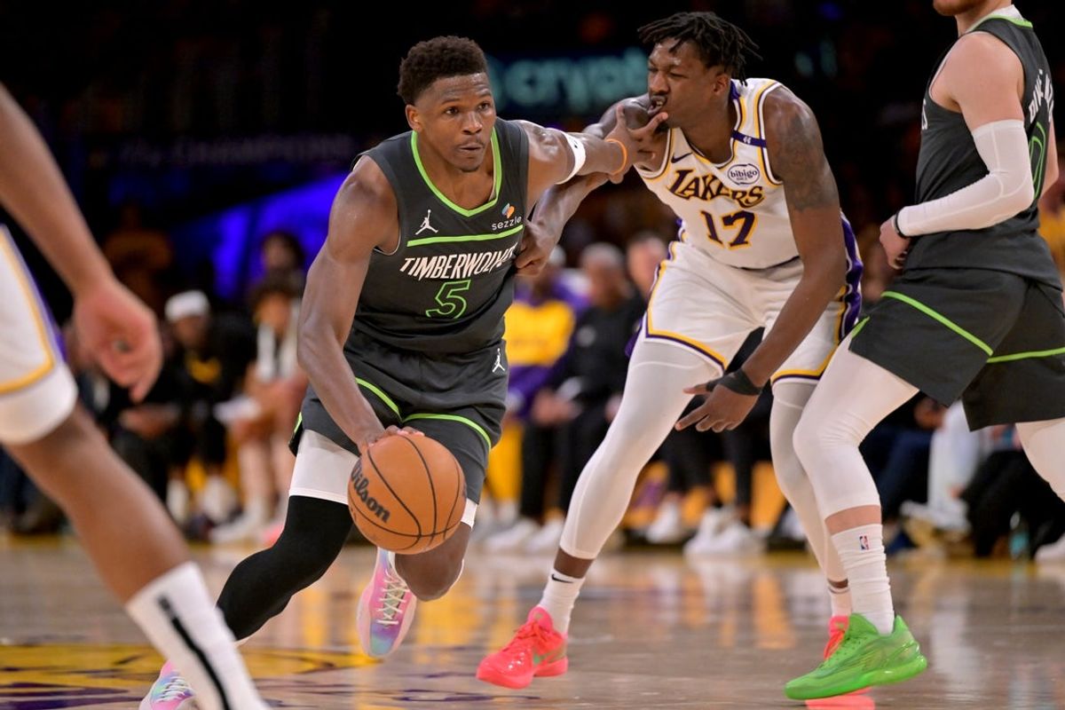 Apr 19, 2025; Los Angeles, California, USA; Minnesota Timberwolves guard Anthony Edwards (5) drives past Los Angeles Lakers forward Dorian Finney-Smith (17) in the second half at Crypto.com Arena. Mandatory Credit: Jayne Kamin-Oncea-Imagn Images