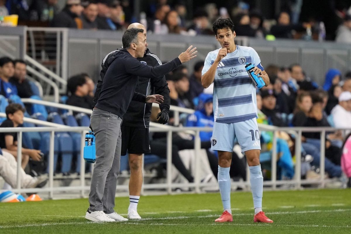 Apr 19, 2025; San Jose, California, USA; Sporting Kansas City interim head coach Kerry Zavagnin (left) talks with forward Daniel Salloi (10) during the second half against the San Jose Earthquakes at PayPal Park. Mandatory Credit: Darren Yamashita-Imagn Images