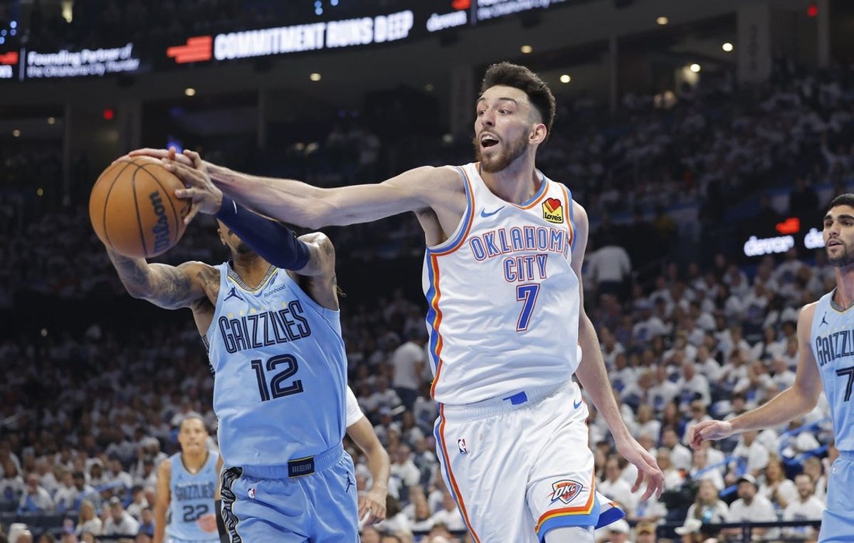 Apr 20, 2025; Oklahoma City, Oklahoma, USA; Oklahoma City Thunder forward Chet Holmgren (7) and Memphis Grizzlies guard Ja Morant (12) reach for a rebound during the second quarter at Paycom Center. Mandatory Credit: Alonzo Adams-Imagn Images
