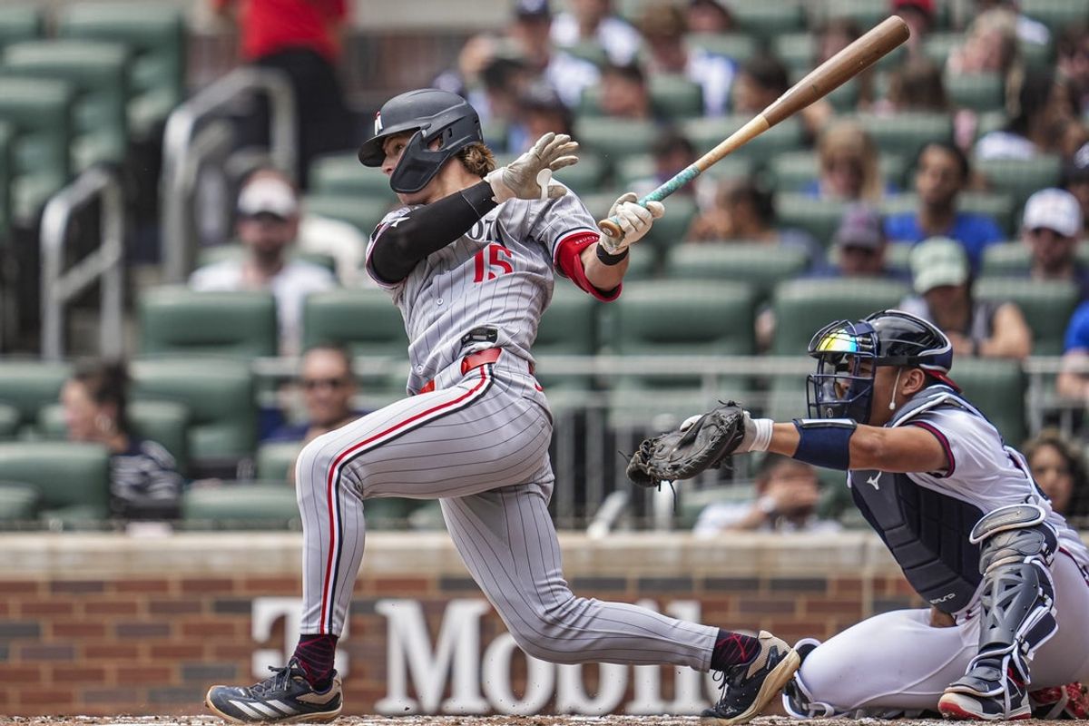 Apr 20, 2025; Cumberland, Georgia, USA; Minnesota Twins designated hitter  Luke Keaschall (15) hits a single against the Atlanta Braves during the third inning at Truist Park. Mandatory Credit: Dale Zanine-Imagn Images