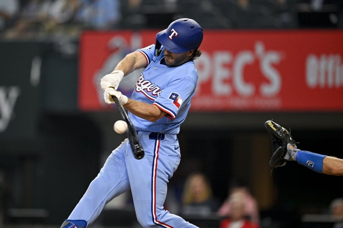 Apr 20, 2025; Arlington, Texas, USA; Texas Rangers left fielder Josh Smith (8) hits a single against the Los Angeles Dodgers during the third inning at Globe Life Field. Mandatory Credit: Jerome Miron-Imagn Images