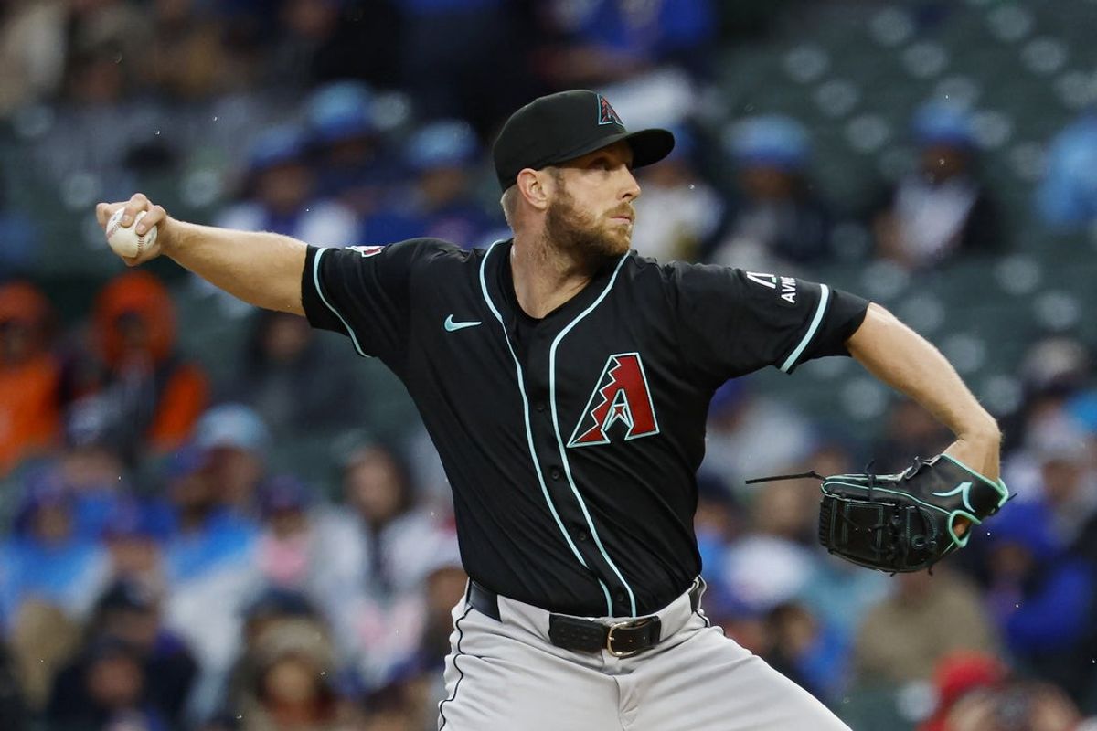 Apr 20, 2025; Chicago, Illinois, USA; Arizona Diamondbacks starting pitcher Merrill Kelly (29) delivers a pitch against the Chicago Cubs during the first inning at Wrigley Field. Mandatory Credit: Kamil Krzaczynski-Imagn Images