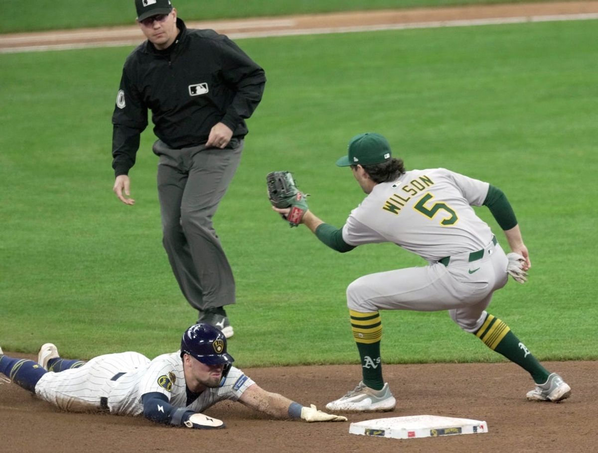 Milwaukee Brewers' Caleb Durbin (21) beats the throw to Oakland Athletics shortstop Jacob Wilson (5) to steal second base during the fourth inning of their game Sunday, April 20, 2025 at American Family Field in Milwaukee, Wisconsin.