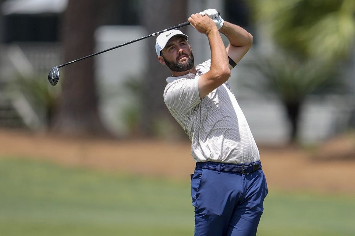 Apr 20, 2025; Hilton Head, South Carolina, USA; Scottie Scheffler hits his approach shot to the second green during the final round of the RBC Heritage golf tournament. Mandatory Credit: Jim Dedmon-Imagn Images
