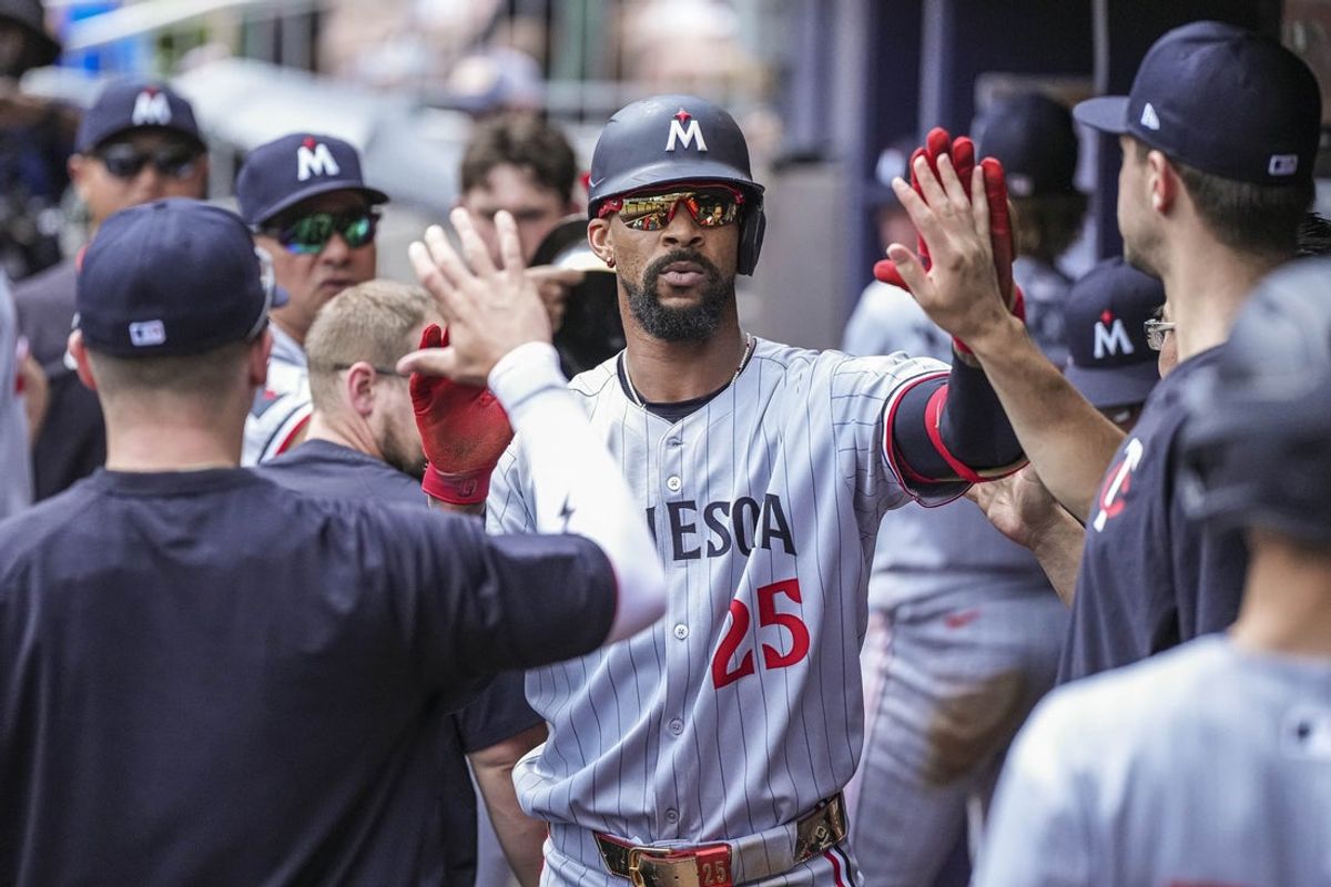 Apr 20, 2025; Cumberland, Georgia, USA; Minnesota Twins center fielder Byron Buxton (25) gets high fives in the dugout after hitting a home run against the Atlanta Braves during the seventh inning at Truist Park. Mandatory Credit: Dale Zanine-Imagn Images