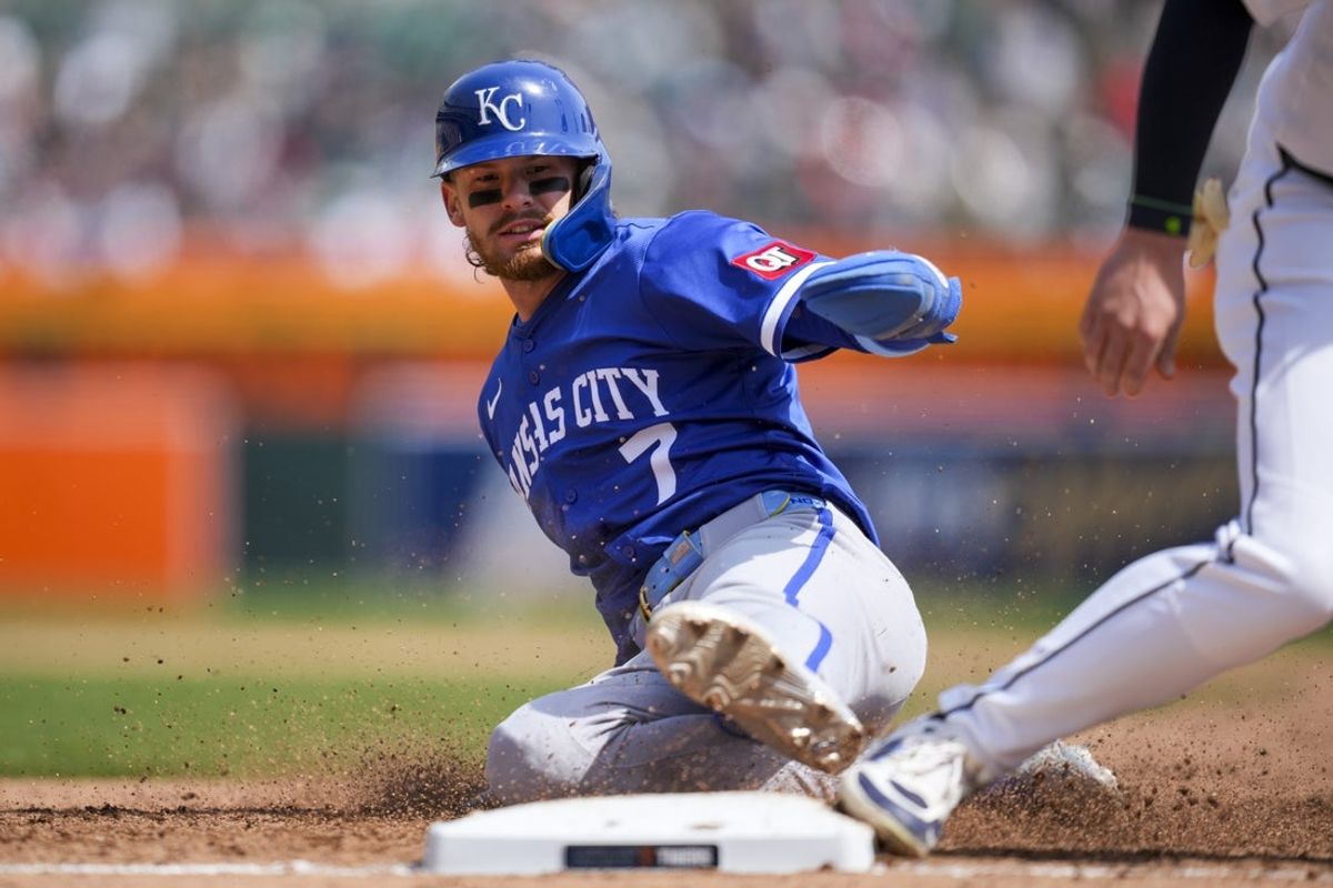 Apr 20, 2025; Detroit, Michigan, USA; Kansas City Royals shortstop Bobby Witt Jr. (7) slides back into first base safely against the Detroit Tigers in the fifth inning at Comerica Park. Mandatory Credit: Aaron Doster-Imagn Images