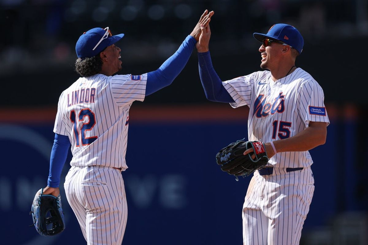 Apr 20, 2025; New York City, New York, USA; New York Mets shortstop Francisco Lindor (12) and right fielder Tyrone Taylor (15) celebrate after defeating the St. Louis Cardinals at Citi Field. Mandatory Credit: Vincent Carchietta-Imagn Images