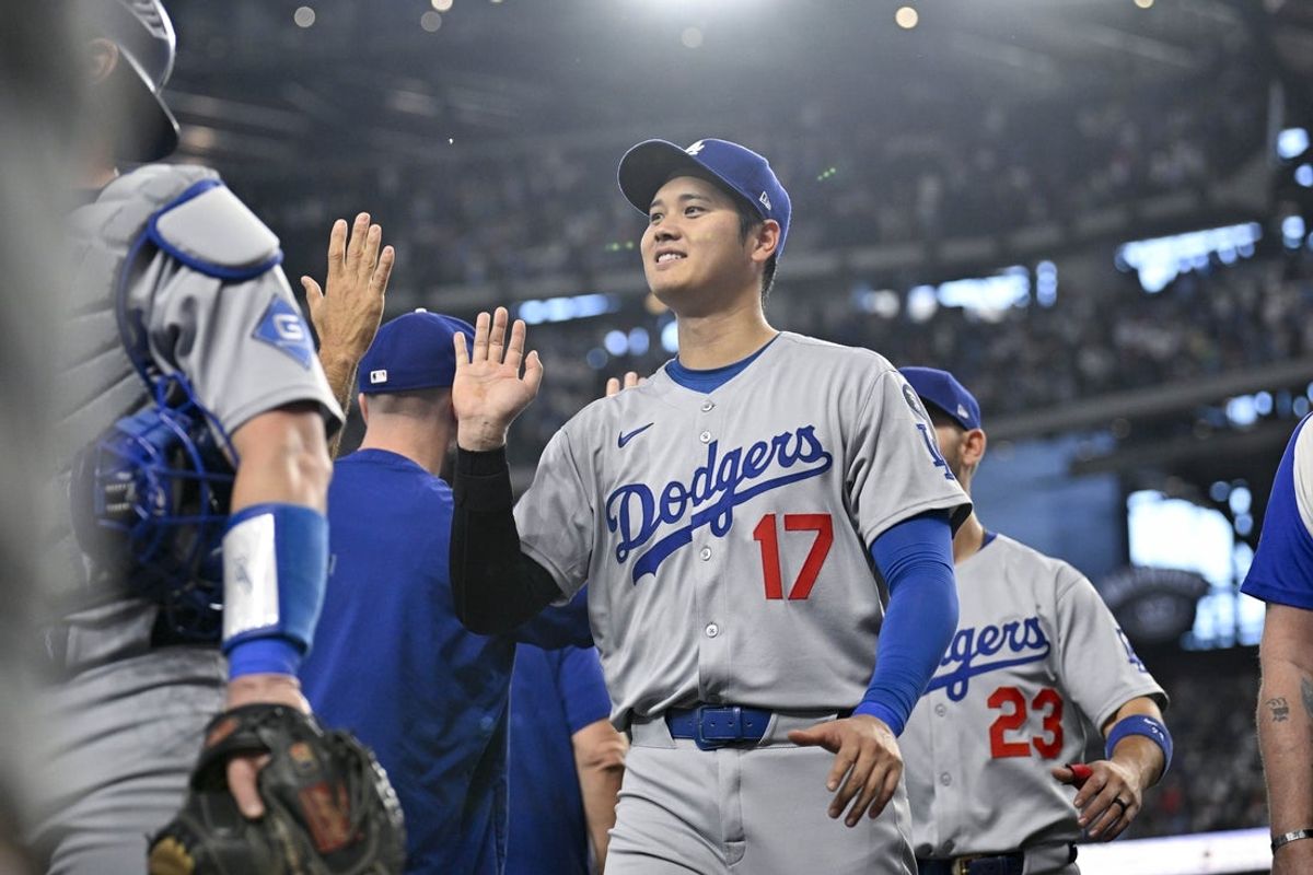Apr 20, 2025; Arlington, Texas, USA; Los Angeles Dodgers designated hitter Shohei Ohtani (17) celebrates with his teammates after the Dodgers defeat the Texas Rangers at Globe Life Field. Mandatory Credit: Jerome Miron-Imagn Images
