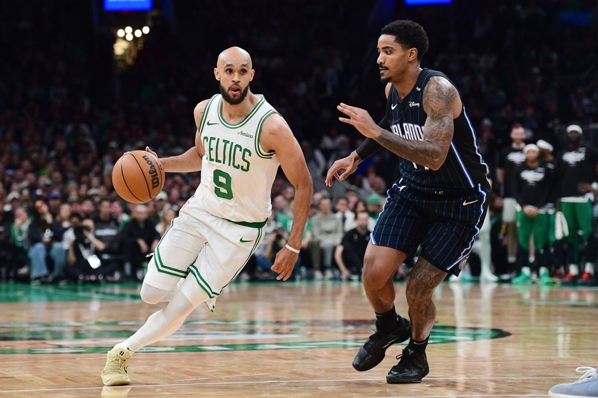 Apr 20, 2025; Boston, Massachusetts, USA; Boston Celtics guard Derrick White (9) controls the ball while the Orlando Magic defend during the second half at TD Garden. Mandatory Credit: Bob DeChiara-Imagn Images