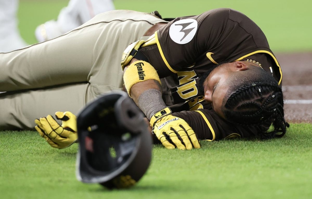 Apr 20, 2025; Houston, Texas, USA;San Diego Padres designated hitter Luis Arraez (4) lies on the field after colliding with Houston Astros first baseman Christian Walker (8) (not pictured )on the first base line  in the first inning  at Daikin Park. Mandatory Credit: Thomas Shea-Imagn Images