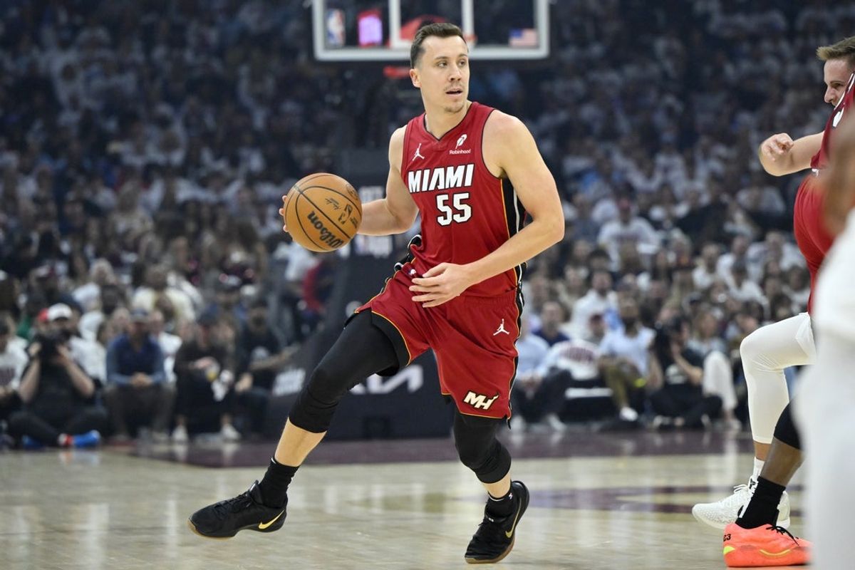 Apr 20, 2025; Cleveland, Ohio, USA; Miami Heat forward Duncan Robinson (55) dribbles the ball in the first quarter against the Cleveland Cavaliers at Rocket Arena. Mandatory Credit: David Richard-Imagn Images
