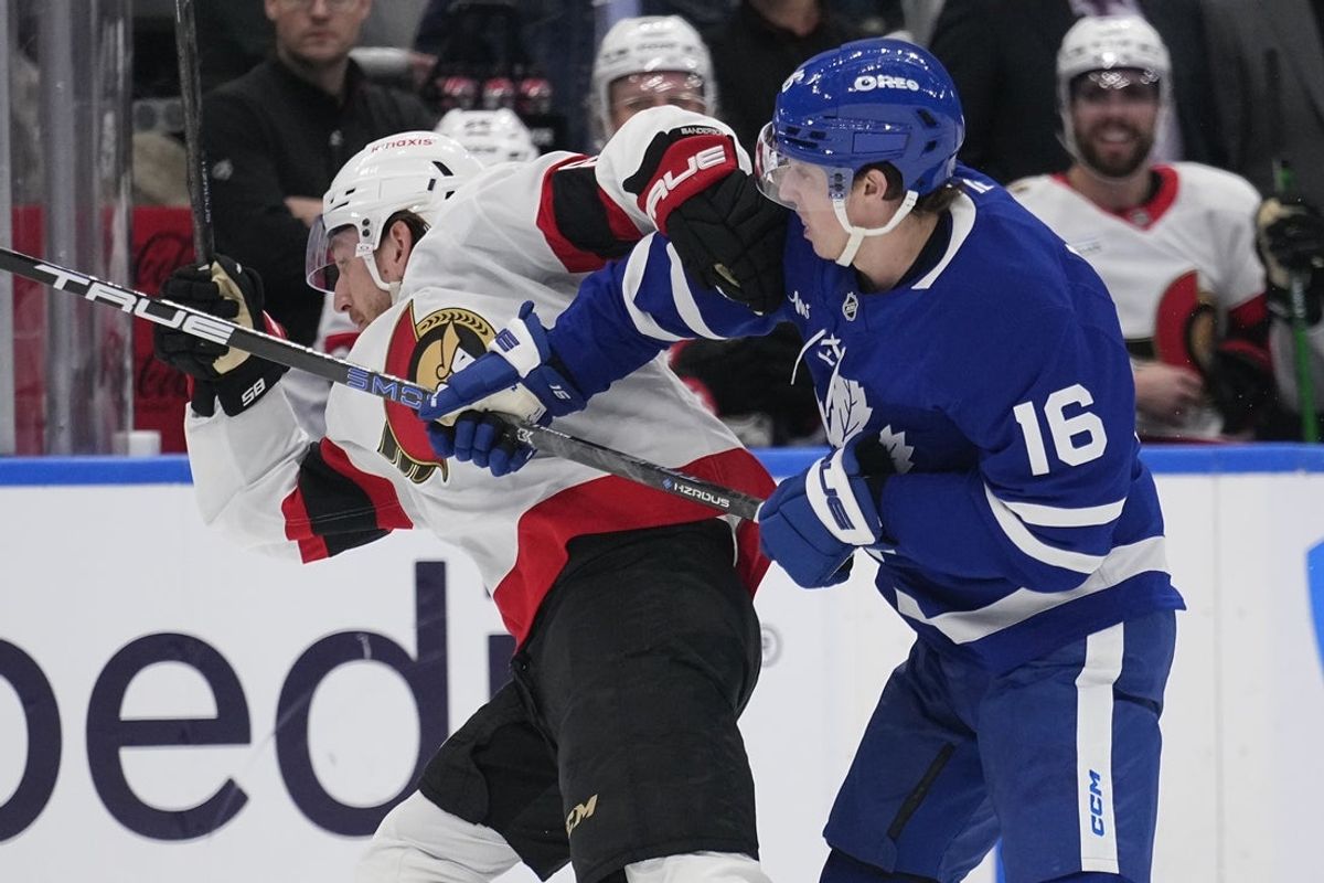 Apr 20, 2025; Toronto, Ontario, CAN; Toronto Maple Leafs forward Mitch Marner (16) checks Ottawa Senators defenseman Jake Sanderson (85) during the second period of game one of the first round of the 2025 Stanley Cup Playoffs at Scotiabank Arena. Mandatory Credit: John E. Sokolowski-Imagn Images