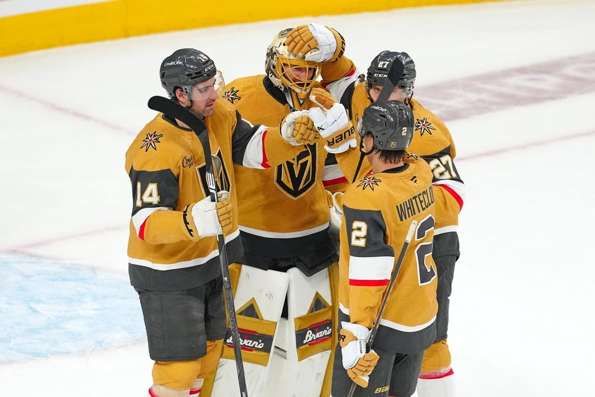 Apr 20, 2025; Las Vegas, Nevada, USA; Vegas Golden Knights goaltender Adin Hill (33) celebrates with defenseman Nicolas Hague (14), defenseman Shea Theodore (27), and defenseman Zach Whitecloud (2) after they defeated the Minnesota Wild 4-2 in game one of the first round of the 2025 Stanley Cup Playoffs at T-Mobile Arena. Mandatory Credit: Stephen R. Sylvanie-Imagn Images