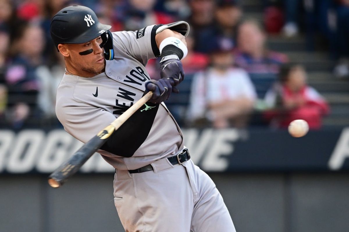 Apr 21, 2025; Cleveland, Ohio, USA; New York Yankees right fielder Aaron Judge (99) hits a double during the third inning against the Cleveland Guardians at Progressive Field. Mandatory Credit: David Dermer-Imagn Images