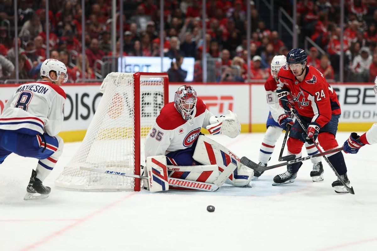 Apr 21, 2025; Washington, District of Columbia, USA; Montreal Canadiens goaltender Sam Montembeault (35) makes a save in front of Washington Capitals center Connor McMichael (24) in the third period in game one of the first round of the 2025 Stanley Cup Playoffs at Capital One Arena. Mandatory Credit: Geoff Burke-Imagn Images