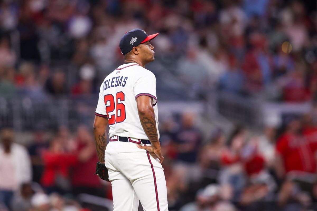 Apr 21, 2025; Atlanta, Georgia, USA; Atlanta Braves relief pitcher Raisel Iglesias (26) reacts after giving up a home run against the St. Louis Cardinals in the ninth inning at Truist Park. Mandatory Credit: Brett Davis-Imagn Images