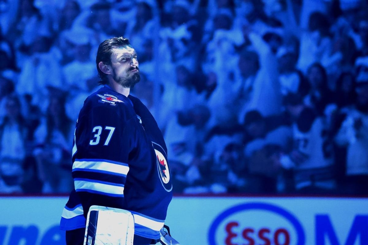 Apr 21, 2025; Winnipeg, Manitoba, CAN; Winnipeg Jets goaltender Connor Hellebuyck (37) looks on during the national anthems before a game against the St. Louis Blues in game two of the first round of the 2025 Stanley Cup Playoffs at Canada Life Centre. Mandatory Credit: James Carey Lauder-Imagn Images
