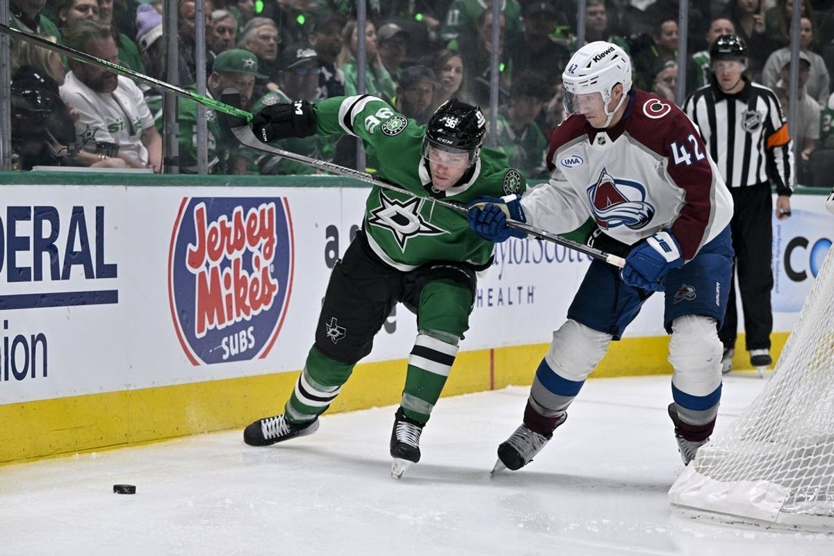 Apr 21, 2025; Dallas, Texas, USA; Dallas Stars right wing Mikko Rantanen (96) and Colorado Avalanche defenseman Josh Manson (42) chase the puck during the overtime period in game two of the first round of the 2025 Stanley Cup Playoffs at American Airlines Center. Mandatory Credit: Jerome Miron-Imagn Images