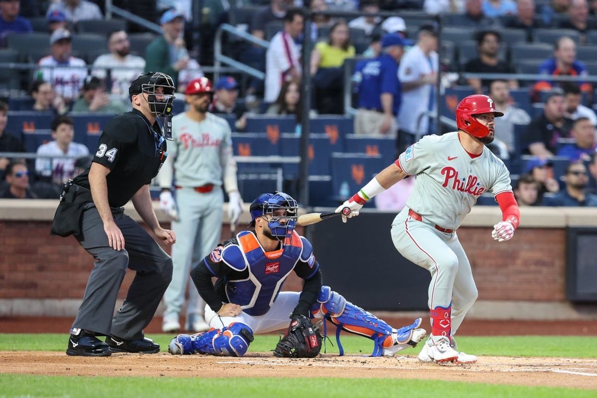 Apr 22, 2025; New York City, New York, USA;  Philadelphia Phillies designated hitter Kyle Schwarber (12) hits a single in the first inning against the New York Mets at Citi Field. Mandatory Credit: Wendell Cruz-Imagn Images