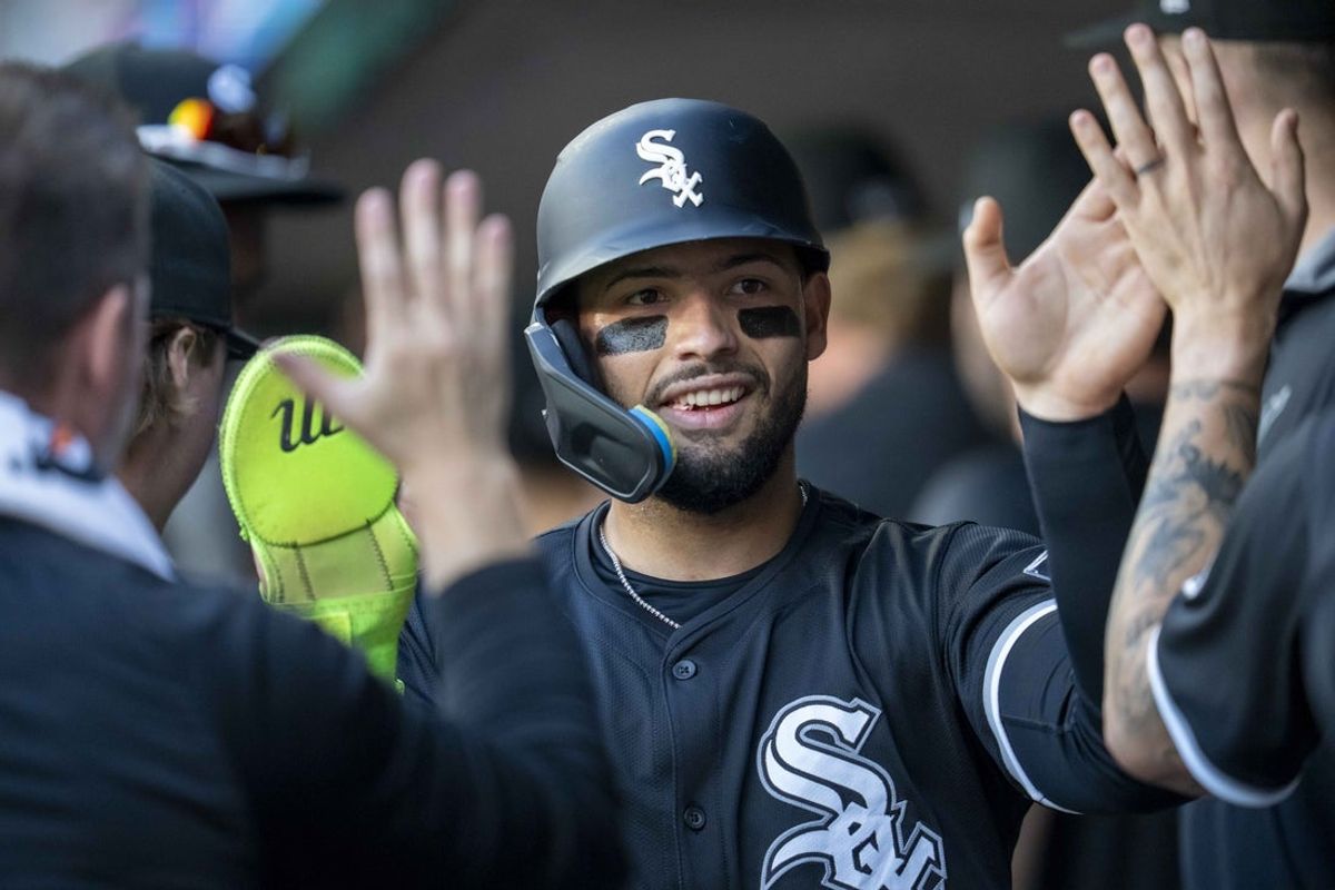 Apr 22, 2025; Minneapolis, Minnesota, USA; Chicago White Sox catcher Edgar Quero (7) celebrates in the dugout after scoring a run against the Minnesota Twins in the second inning at Target Field. Mandatory Credit: Jesse Johnson-Imagn Images