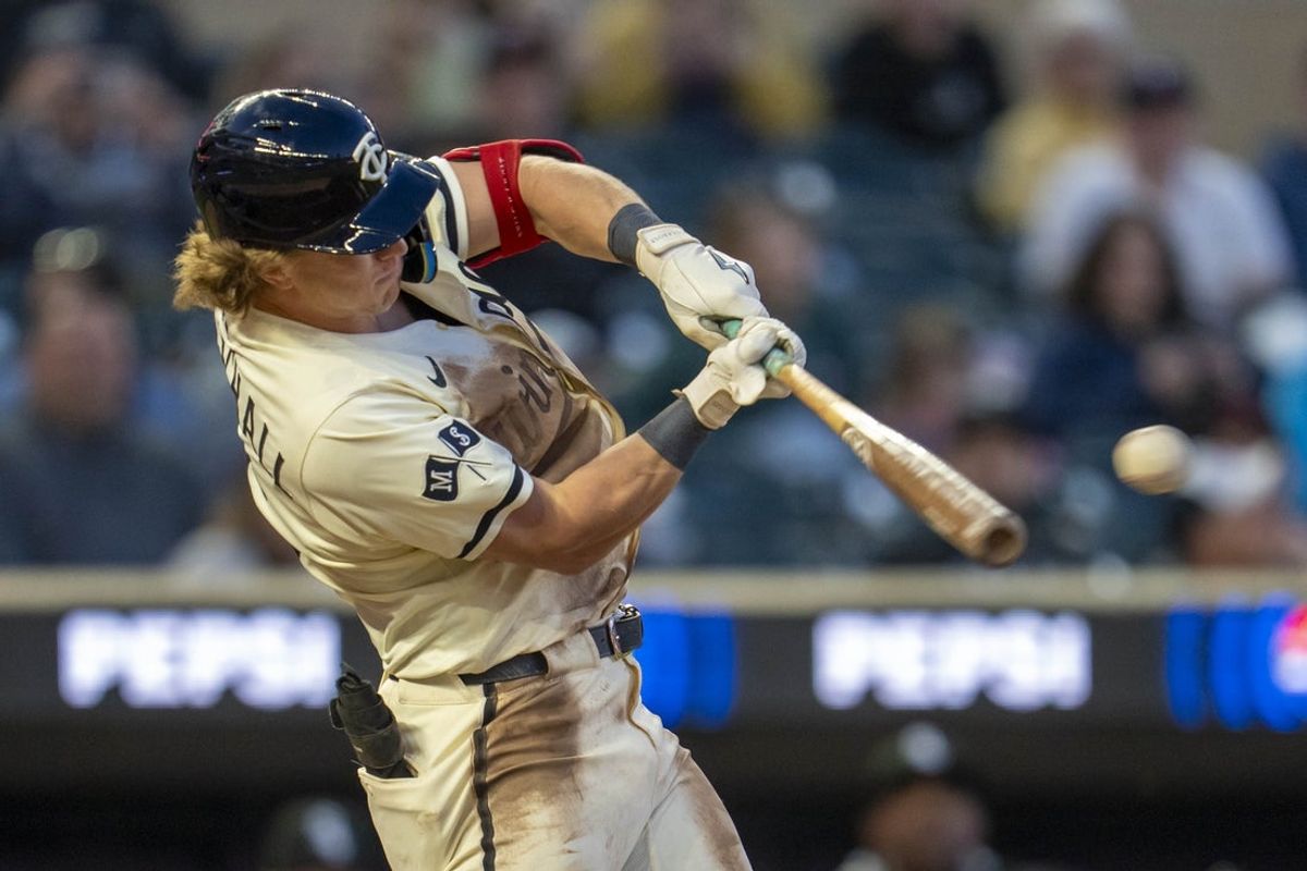 Apr 22, 2025; Minneapolis, Minnesota, USA; Minnesota Twins designated hitter Luke Keaschall (15) hits a single against the Chicago White Sox in the fifth inning at Target Field. Mandatory Credit: Jesse Johnson-Imagn Images