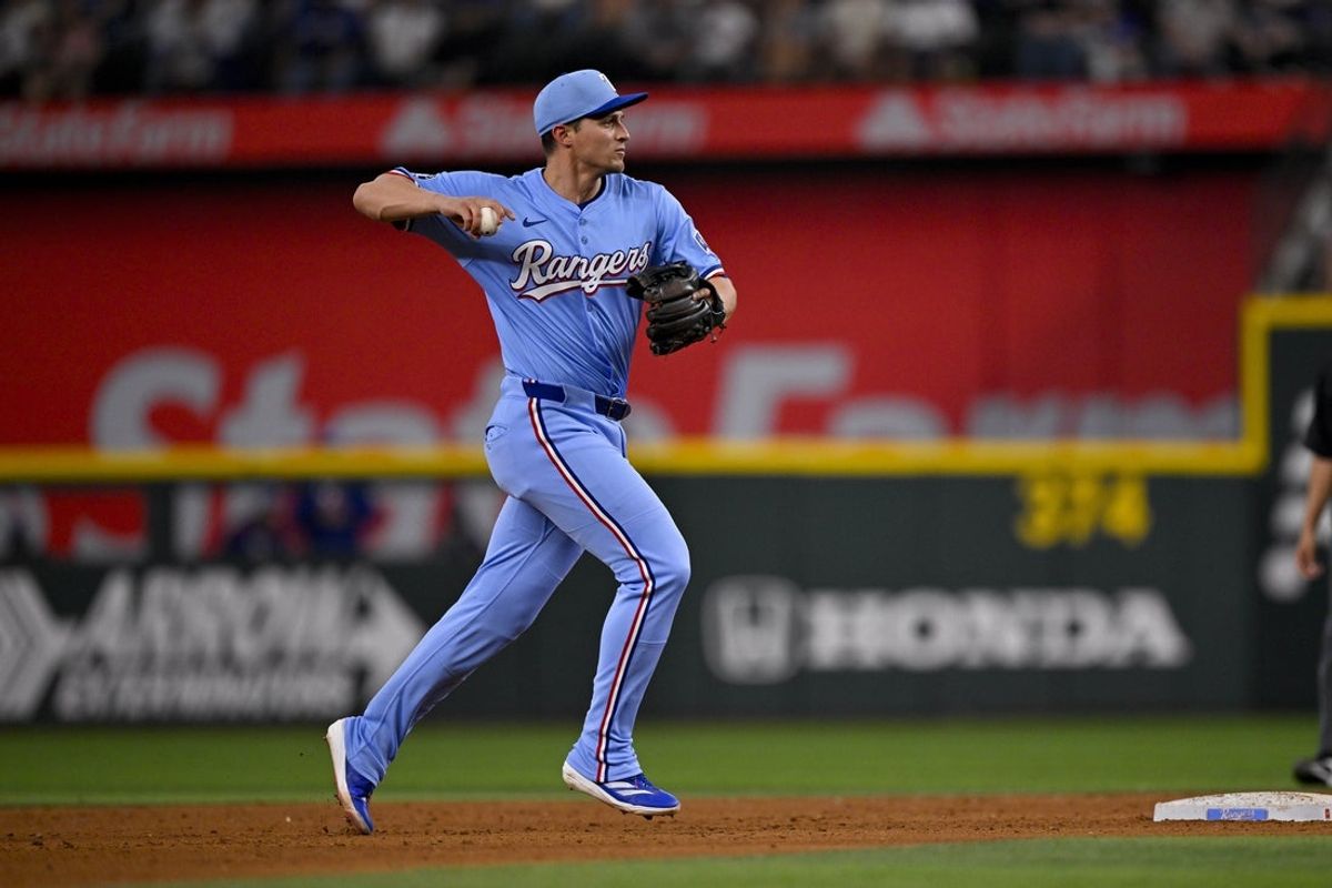 Apr 20, 2025; Arlington, Texas, USA; Texas Rangers shortstop Corey Seager (5) in action during the game between the Texas Rangers and the Los Angeles Dodgers at Globe Life Field. Mandatory Credit: Jerome Miron-Imagn Images