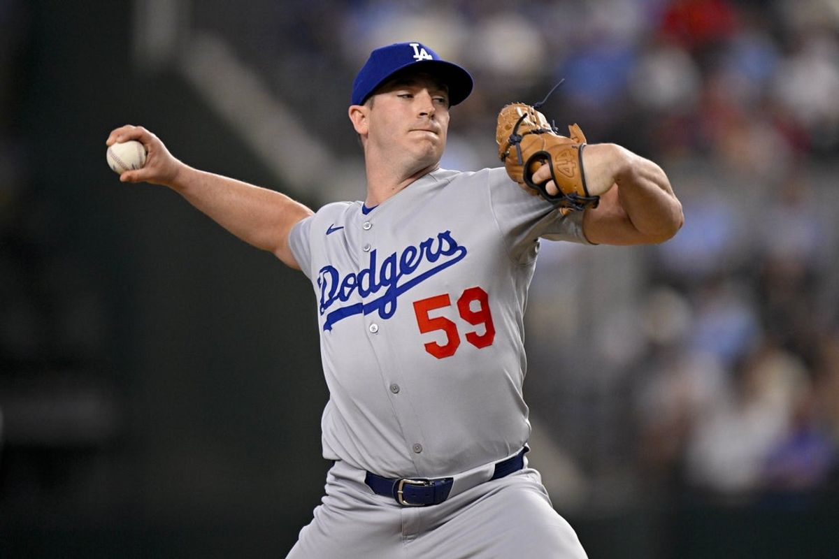 Apr 20, 2025; Arlington, Texas, USA; Los Angeles Dodgers relief pitcher Evan Phillips (59) pitches during the game between the Texas Rangers and the Los Angeles Dodgers at Globe Life Field. Mandatory Credit: Jerome Miron-Imagn Images