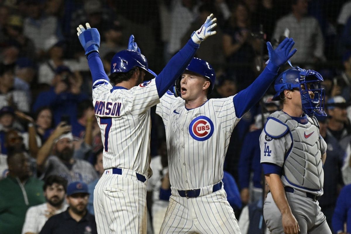 Apr 22, 2025; Chicago, Illinois, USA;  Chicago Cubs outfielder Pete Crow-Armstrong (4) celebrates with Chicago Cubs shortstop Dansby Swanson (7)  after they score on his two run home run during the fifth inning against the Los Angeles Dodgers at Wrigley Field. Mandatory Credit: Matt Marton-Imagn Images