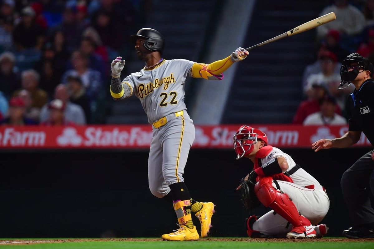 Apr 22, 2025; Anaheim, California, USA; Pittsburgh Pirates designated hitter Andrew McCutchen (22) hits a three run home run against the Los Angeles Angels during the fourth inning at Angel Stadium. Mandatory Credit: Gary A. Vasquez-Imagn Images