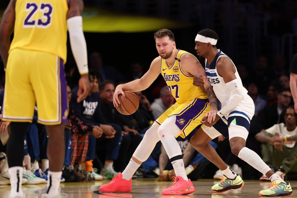 Apr 22, 2025; Los Angeles, California, USA; Los Angeles Lakers guard Luka Doncic (77) posts up against Minnesota Timberwolves forward Jaden McDaniels (3) during the first quarter of game two of first round for the 2024 NBA Playoffs at Crypto.com Arena. Mandatory Credit: Kiyoshi Mio-Imagn Images
