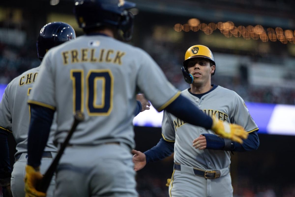 Apr 22, 2025; San Francisco, California, USA; Milwaukee Brewers designated hitter Christian Yelich (22) is greeted by his teammates Jackson Chourio (11) and Sal Frelick (10) as he scores during the third inning against the San Francisco Giants at Oracle Park. Mandatory Credit: D. Ross Cameron-Imagn Images