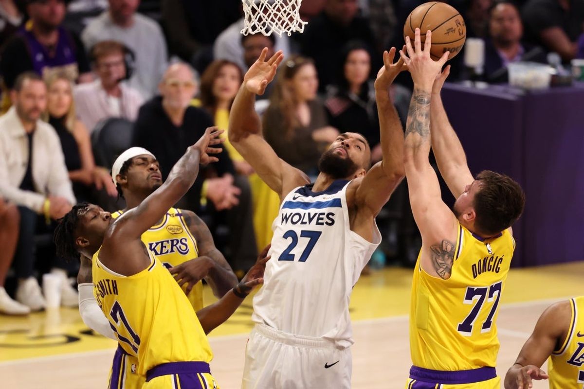 Apr 22, 2025; Los Angeles, California, USA; Los Angeles Lakers guard Luka Doncic (77) rebounds a ball against Minnesota Timberwolves center Rudy Gobert (27) during the first quarter of game two of first round for the 2024 NBA Playoffs at Crypto.com Arena. Mandatory Credit: Kiyoshi Mio-Imagn Images