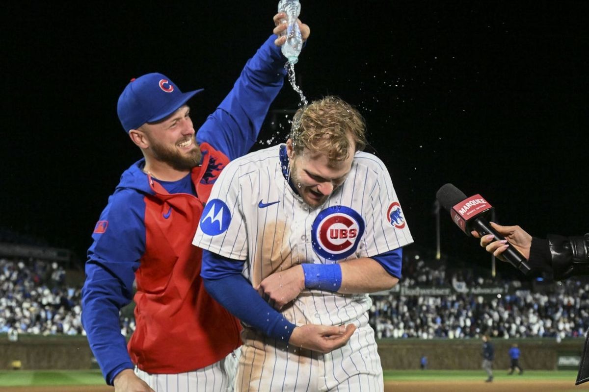 Apr 22, 2025; Chicago, Illinois, USA;  Chicago Cubs first baseman Michael Busch (29) throws water on Chicago Cubs outfielder Ian Happ (8) after the game against the Los Angeles Dodgers at Wrigley Field. Mandatory Credit: Matt Marton-Imagn Images
