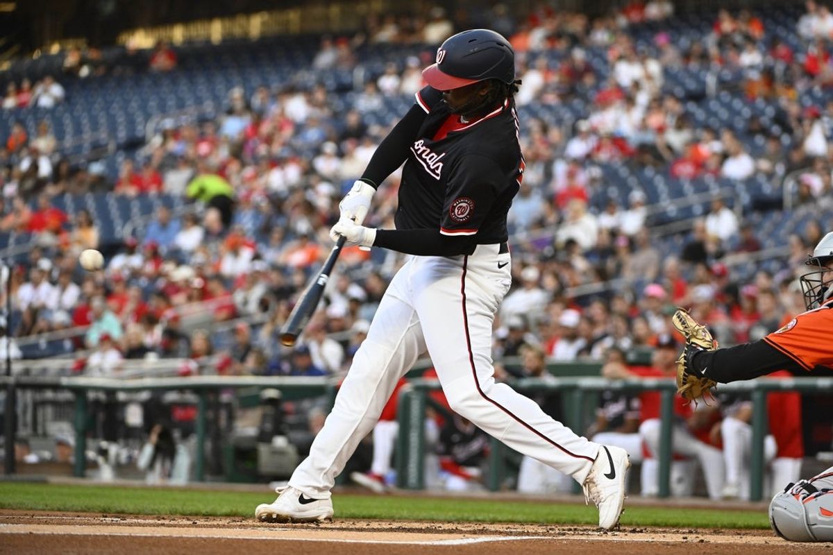 Apr 23, 2025; Washington, District of Columbia, USA; Washington Nationals first baseman Josh Bell (19) hits a two-run home run against the Baltimore Orioles during the first inning at Nationals Park. Mandatory Credit: Brad Mills-Imagn Images