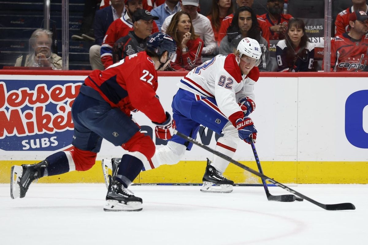 Apr 23, 2025; Washington, District of Columbia, USA; Montreal Canadiens right wing Patrik Laine (92) skates with the puck as Washington Capitals right wing Brandon Duhaime (22) chases in the first period in game two of the first round of the 2025 Stanley Cup Playoffs at Capital One Arena. Mandatory Credit: Geoff Burke-Imagn Images
