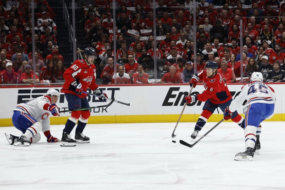 Apr 23, 2025; Washington, District of Columbia, USA; Washington Capitals defenseman Jakob Chychrun (6) shoots the puck as Montreal Canadiens defenseman Alexandre Carrier (45) defends in the first period in game two of the first round of the 2025 Stanley Cup Playoffs at Capital One Arena. Mandatory Credit: Geoff Burke-Imagn Images