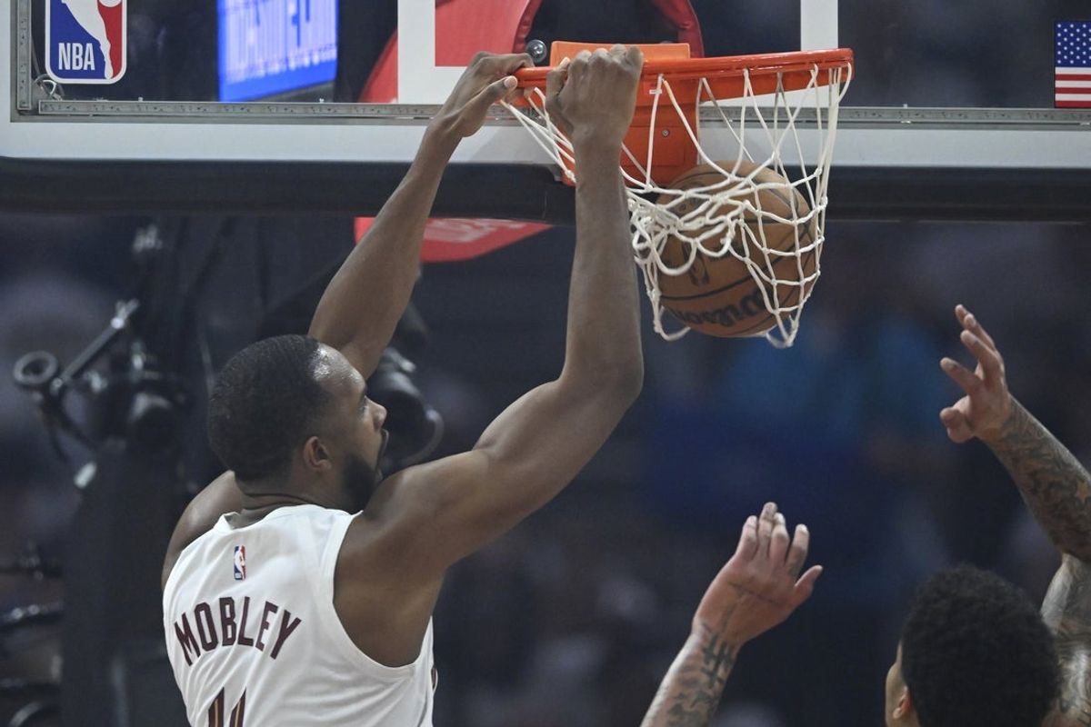 Apr 23, 2025; Cleveland, Ohio, USA; Cleveland Cavaliers forward Evan Mobley (4) dunks against the Miami Heat in the first quarter of game two of the first round of the 2025 NBA Playoffs at Rocket Arena. Mandatory Credit: David Richard-Imagn Images
