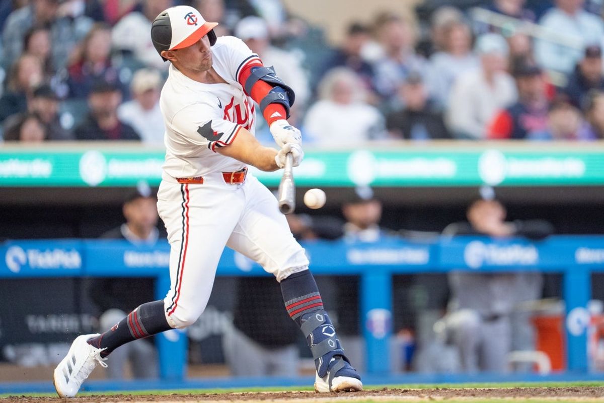 Apr 23, 2025; Minneapolis, Minnesota, USA; Minnesota Twins third base Brooks Lee (2) singles on a ball misplayed by Chicago White Sox shortstop Jacob Amaya (8) in the third inning at Target Field. Mandatory Credit: Matt Blewett-Imagn Images