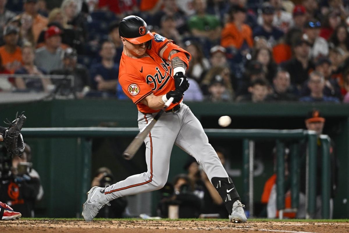 Apr 23, 2025; Washington, District of Columbia, USA; Baltimore Orioles outfielder Tyler O'Neill (9) hits a RBI sacrifice fly against the Washington Nationals during the seventh inning at Nationals Park. Mandatory Credit: Brad Mills-Imagn Images