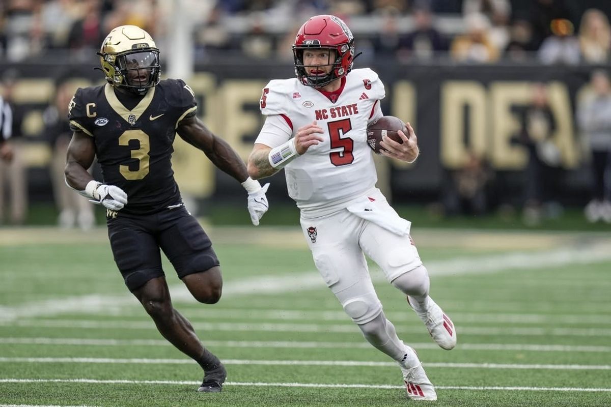 Nov 11, 2023; Winston-Salem, North Carolina, USA; Wake Forest Demon Deacons defensive back Malik Mustapha (3) chases North Carolina State Wolfpack quarterback Brennan Armstrong (5) during the first half at Allegacy Federal Credit Union Stadium.