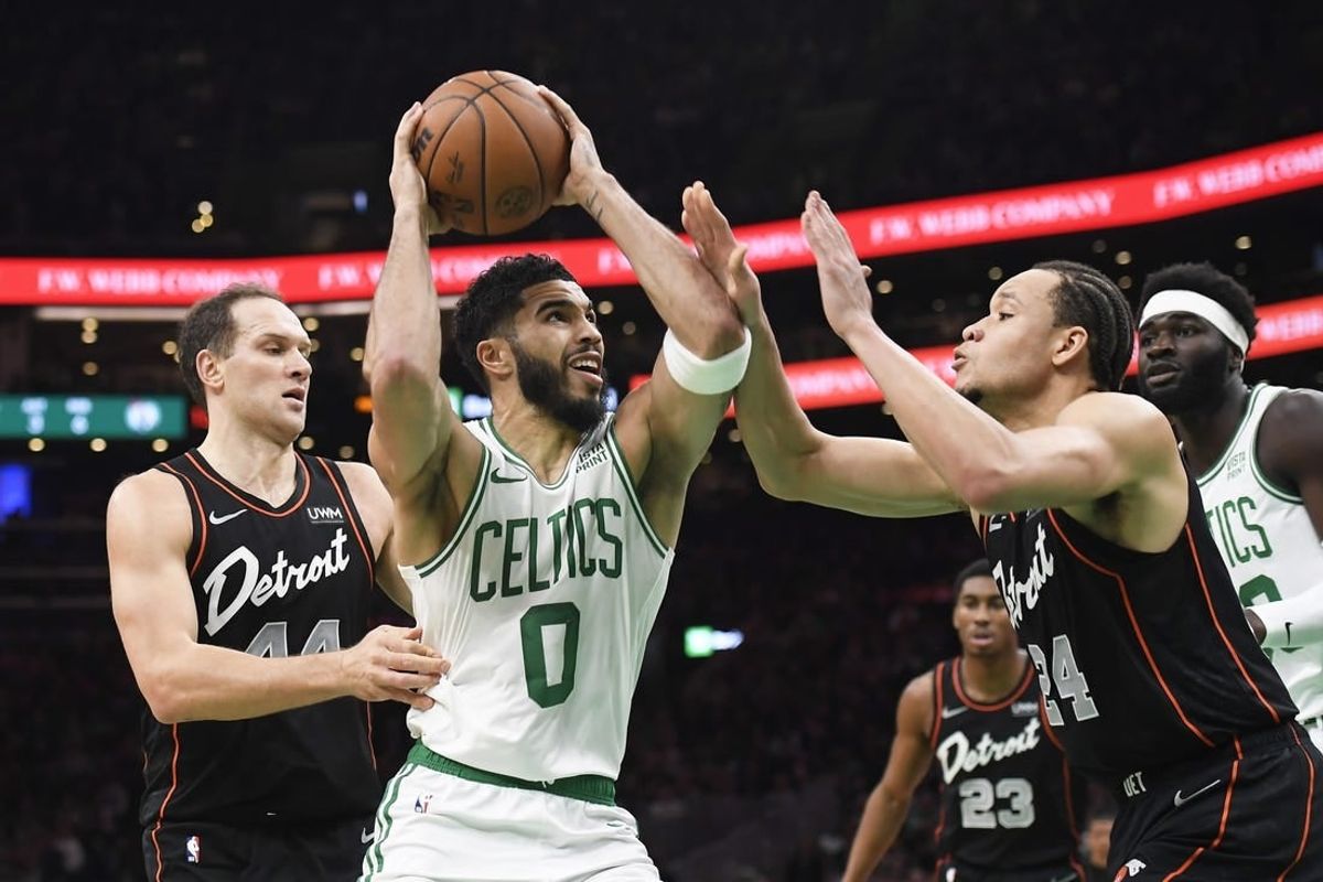 Dec 28, 2023; Boston, Massachusetts, USA;  Boston Celtics forward Jayson Tatum (0) drives to the basket while Detroit Pistons forward Kevin Knox II (24) defends during the first half at TD Garden.