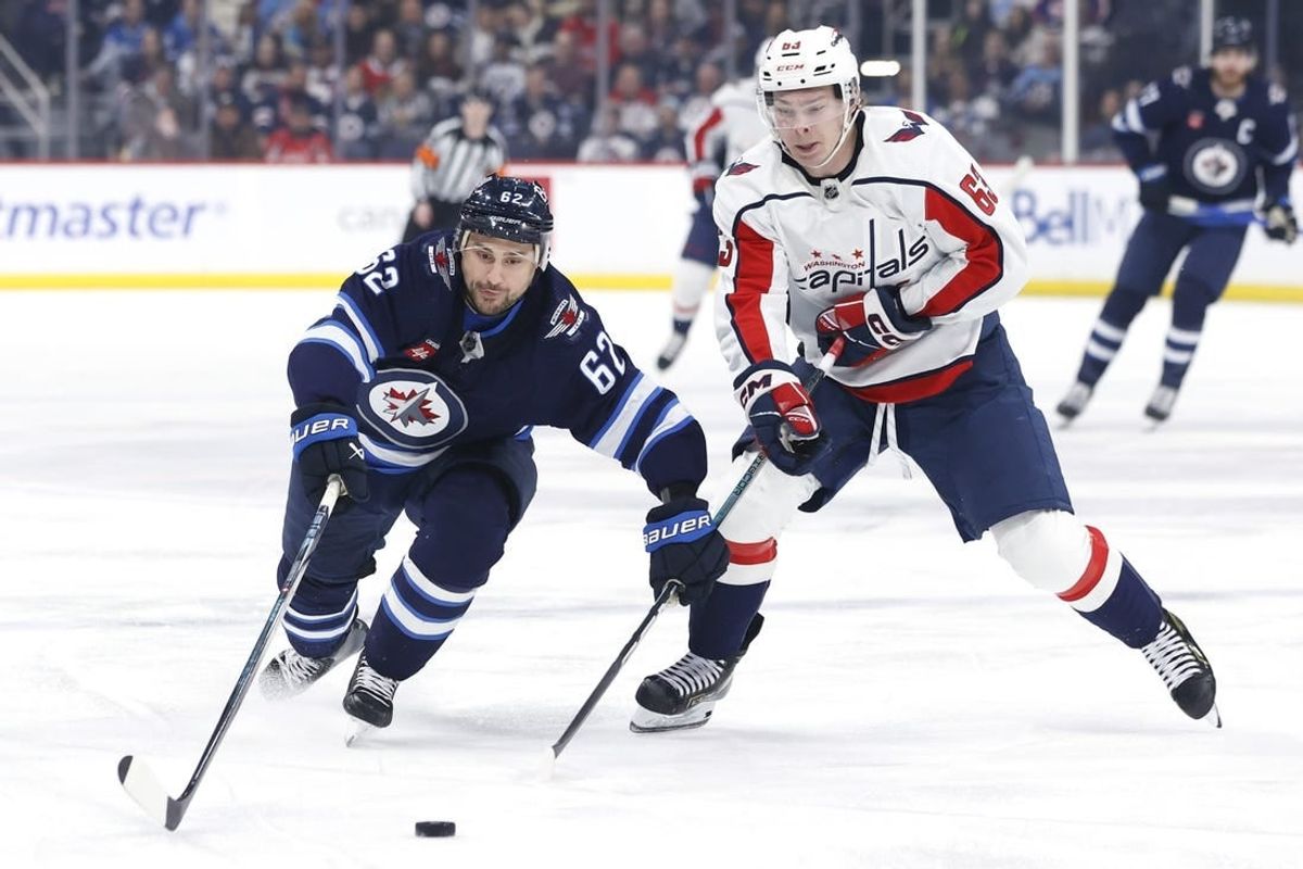 Mar 11, 2024; Winnipeg, Manitoba, CAN; Winnipeg Jets right wing Nino Niederreiter (62) and Washington Capitals left wing Ivan Miroshnichenko (63) chase after the puck in the first period at Canada Life Centre.