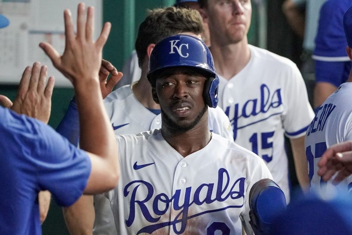 Aug 1, 2023; Kansas City, Missouri, USA; Kansas City Royals second baseman Samad Taylor (0) is congratulated in the dugout against the New York Mets after scoring in the fifth inning at Kauffman Stadium.