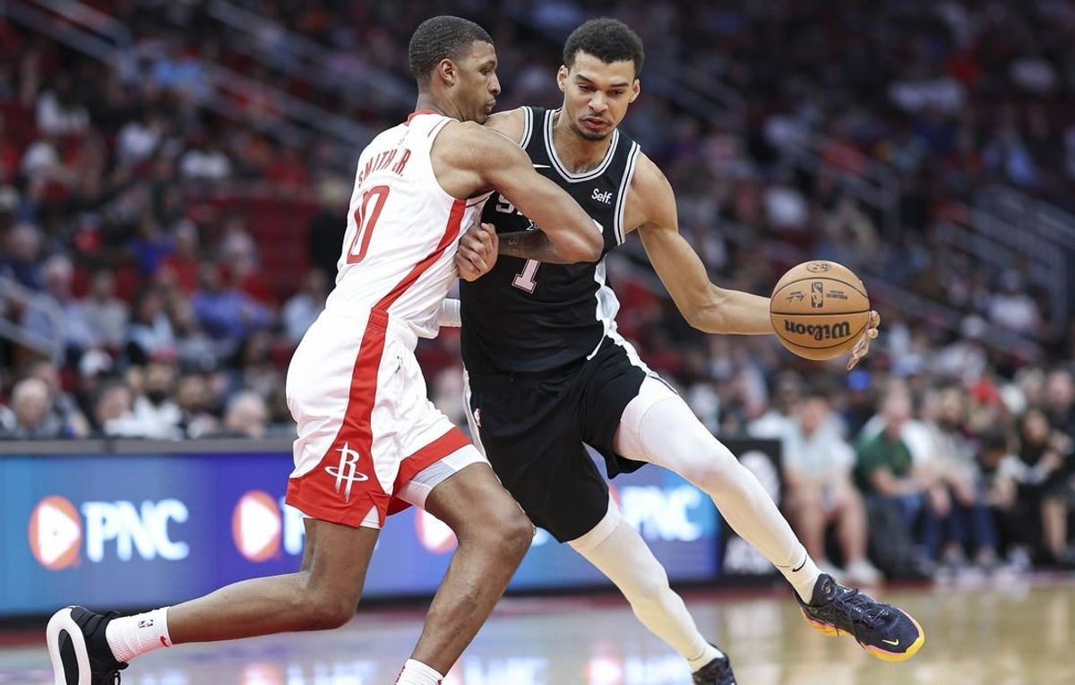 Mar 5, 2024; Houston, Texas, USA; San Antonio Spurs center Victor Wembanyama (1) controls the ball as Houston Rockets forward Jabari Smith Jr. (10) defends during the first quarter at Toyota Center.
