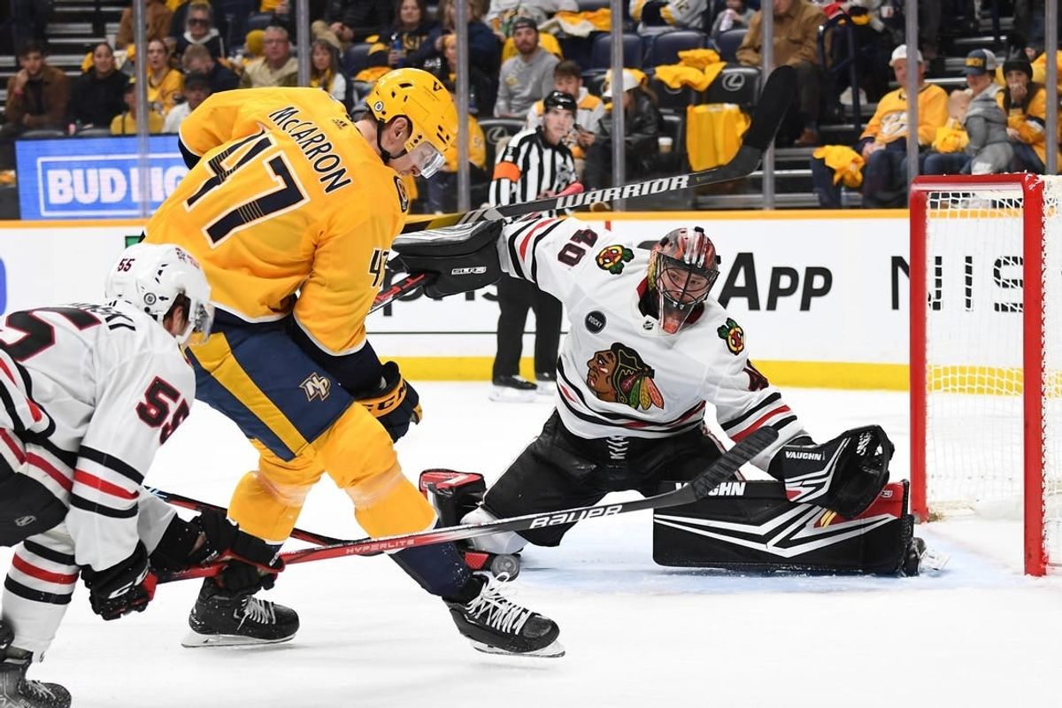Jan 2, 2024; Nashville, Tennessee, USA; Chicago Blackhawks goaltender Arvid Soderblom (40) waits to block a shot by Nashville Predators right wing Michael McCarron (47) during the first period at Bridgestone Arena.