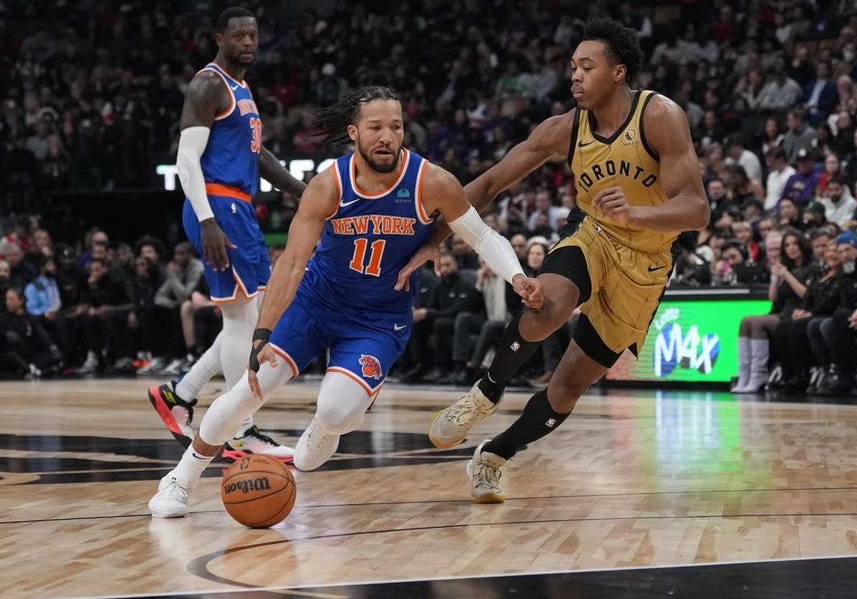 Dec 1, 2023; Toronto, Ontario, CAN; New York Knicks guard Jalen Brunson (11) controls the ball as Toronto Raptors forward Scottie Barnes (4) tries to defend during the first quarter at Scotiabank Arena.