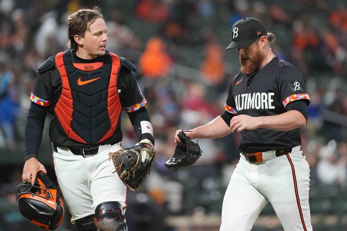May 10, 2024; Baltimore, Maryland, USA; Baltimore Orioles pitcher Craig Kimbrel (right) greeted by catcher Adley Rutschman (left) at the end of the seventh inning against the Arizona Diamondbacks at Oriole Park at Camden Yards.
