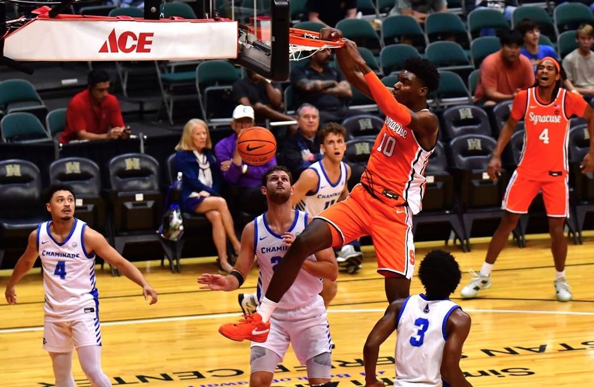 Nov 22, 2023; Honolulu, HI, USA; Syracuse Orange center Naheem McLeod (10) dunks the ball between defenders Chaminade Silverswords forward Wyatt Lowell (25) and forward Chris Bready (3) during the first period at SimpliFi Arena at Stan Sheriff Center.