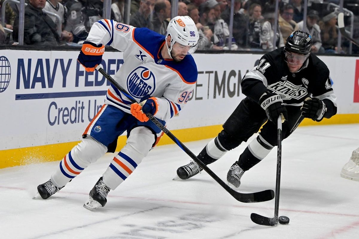 Apr 23, 2025; Los Angeles, California, USA;  Edmonton Oilers defenseman Jake Walman (96) and Los Angeles Kings center Anze Kopitar (11) go for the puck in the first period of game 2 of the 2025 Stanley Cup Playoffs at Crypto.com Arena. Mandatory Credit: Jayne Kamin-Oncea-Imagn Images